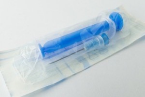Packaged syringe sealed in its sterile barrier pouch