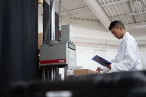 DDL technician recording results at the drop test rig